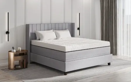 Luxurious grey upholstered mattress on a modern bed frame in a stylish bedroom showcasing quality sleep solutions from The Mattress Underground.