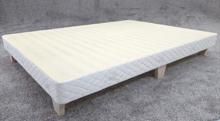 Low profile mattress on wooden slats, plush foam, supportive sleep surface, ideal for back and side sleepers, designed for comfort and durability.